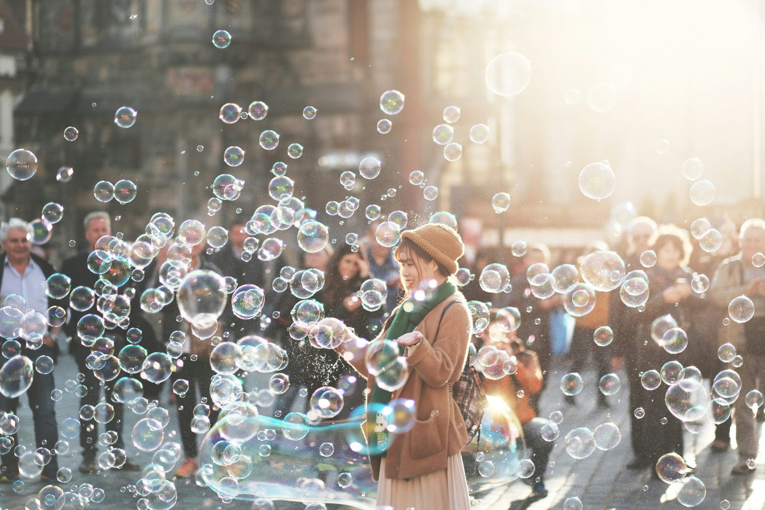 Woman standing in city with lots of bubbles.